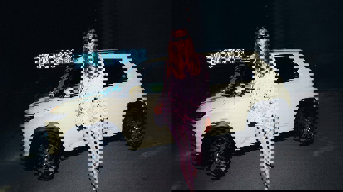 Kvinde der står ved en Hyundai INSTER